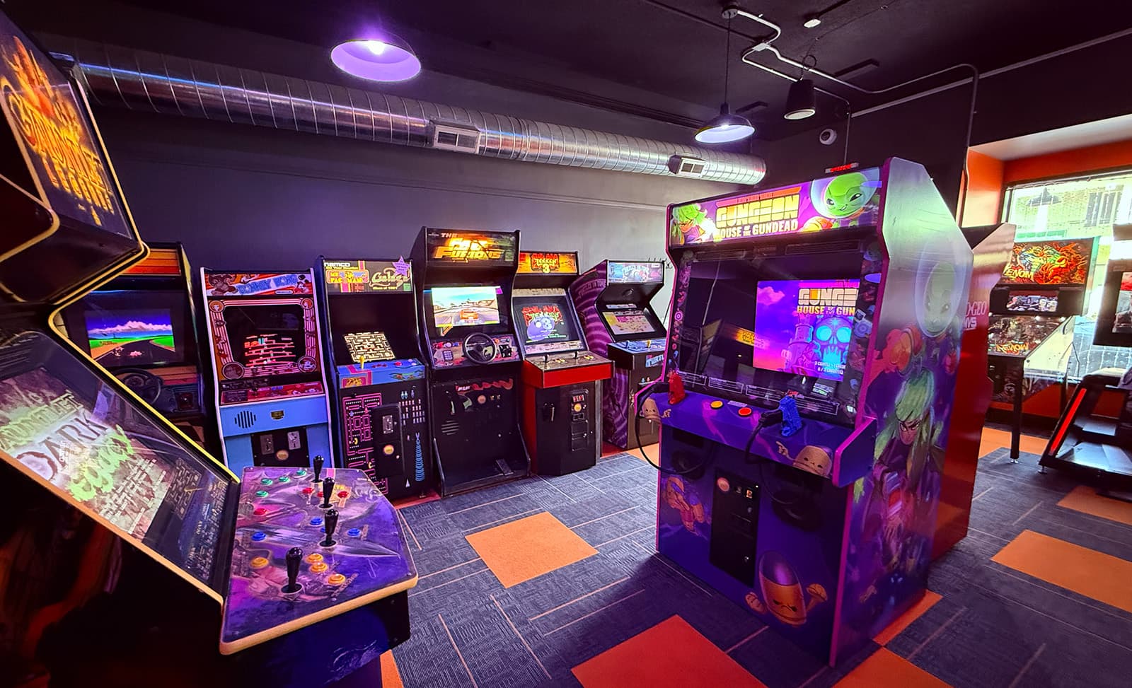 Friends playing arcade games at Hardwired Arcade